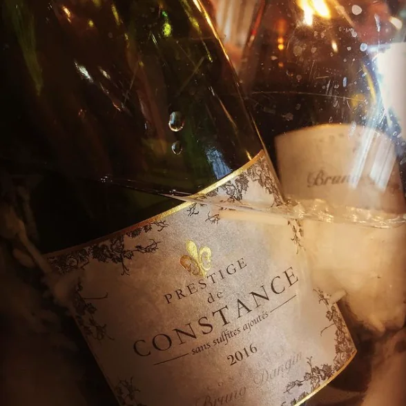 Close-up of Prestige de Constance 2016 wine bottle wrapped with string