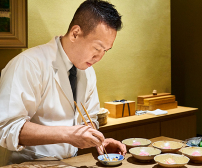 Chef Kazutomo Matayoshi preparing a dish at the counter