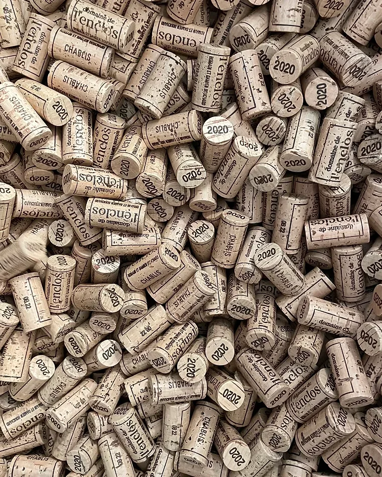 Pile of wine corks showing Domaine de l'enclos and the year 2020 printed on them