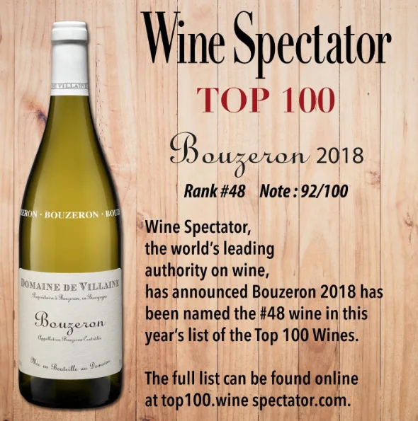 Bottle of Domaine de Villaine Bouzeron 2018 wine on wooden background with Wine Spectator Top 100 text