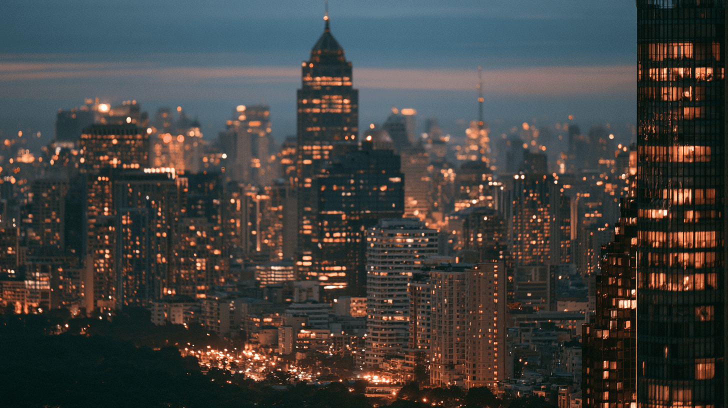 Aerial documentary photograph of a Southeast Asian city skyline at dusk with countless warm window lights