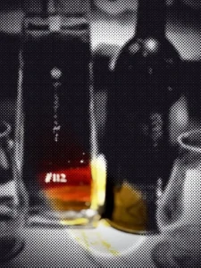 Moving dot illustration of the bottle photo from “Koji Whisky”; a drifting circle reveals the original picture